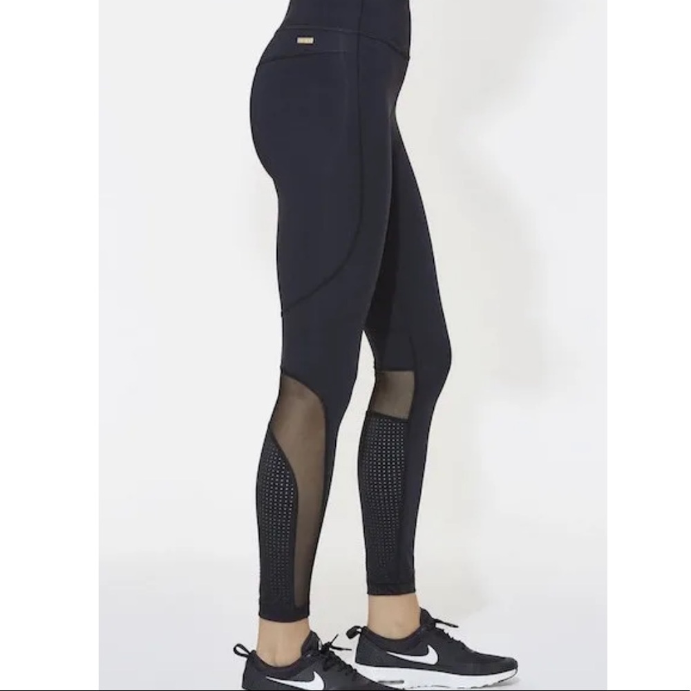 Alala Siren Tight with BABE in white lettering on back calf